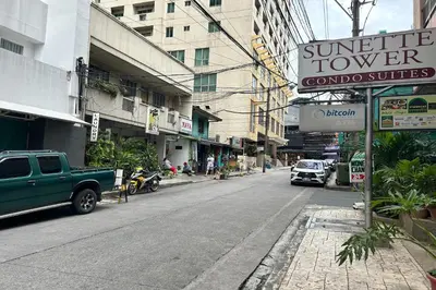a street with cars parked on the side of the road at Sunette Tower Suites Makati City Center in Manila