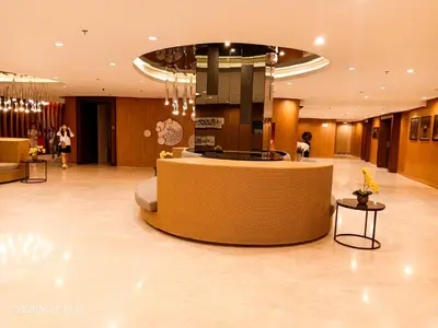 a lobby with a reception desk in a building at Shore 2 Residences 1BR Deluxe Room in MOA Complex in Manila