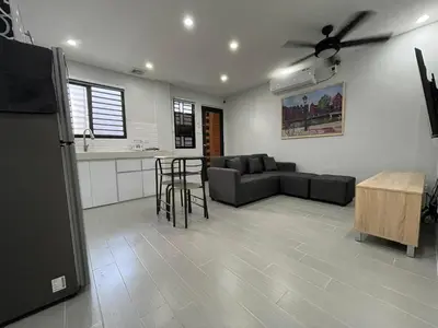 a living room with a couch and a table at Canlubang Luxury Apartment in Canlubang