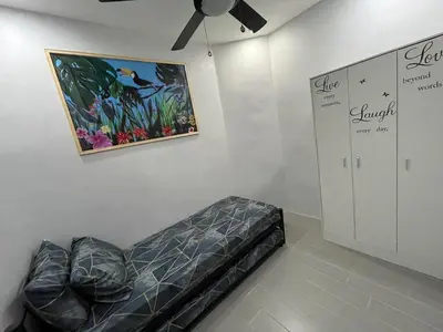 a room with a bed and a painting on the wall at Canlubang Luxury Apartment in Canlubang