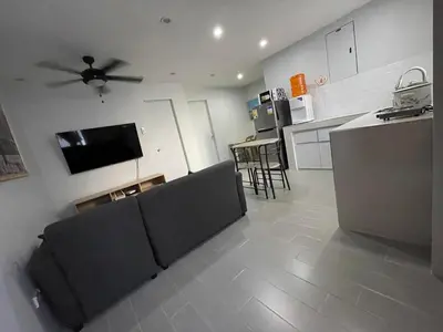 a living room with a couch and a flat screen tv at Canlubang Luxury Apartment in Canlubang