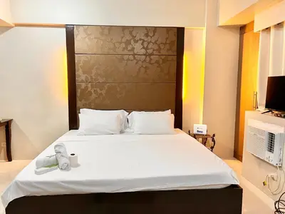 a bedroom with a large bed with a phone on it at Newport Hotel near NAIA Manila Airport Terminal Pasay in Manila