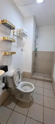 a bathroom with a toilet and a sink at Auberge Condotels at SMDC Hope Residences in Trece Martires