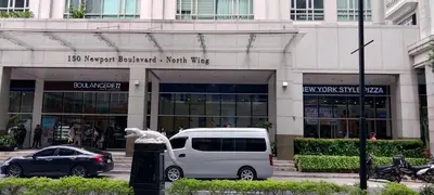 a white van parked in front of a building at Alps Guesthouse at 150 Newport Blvd near T3 in Manila