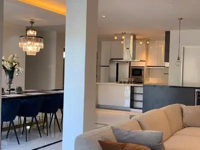 a living room and kitchen with a couch and a table at Luxury 4 Bedroom Apartment in San Andres