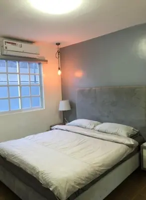 a bedroom with a large white bed with a window at Luxury 4 Bedroom Apartment in San Andres