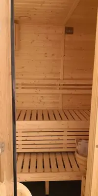 a small wooden sauna with a wooden at Luxury 4 Bedroom Apartment in San Andres