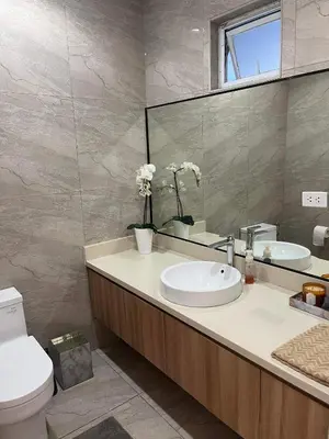 a bathroom with a sink and a toilet and a mirror at Luxury 4 Bedroom Apartment in San Andres