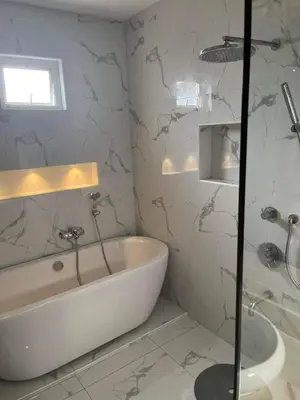 a white bathroom with a tub and a sink at Luxury 4 Bedroom Apartment in San Andres