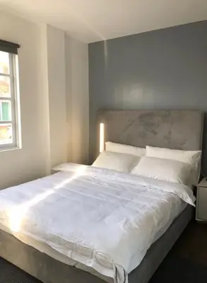 a large white bed in a bedroom with a window at Luxury 4 Bedroom Apartment in San Andres