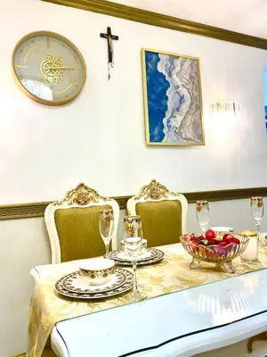 a dining room with a table with a cross on the wall at RK Maisson Roiyale Pasig in Manila