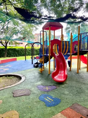 a playground with a red and yellow slide at RK Maisson Roiyale Pasig in Manila