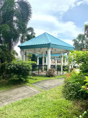 a gazebo with a blue roof in a park at RK Maisson Roiyale Pasig in Manila