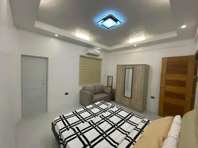 a bedroom with a bed and a couch in it at Mountain View in Binangonan