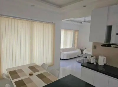a kitchen and living room with a table and a couch at Mountain View in Binangonan