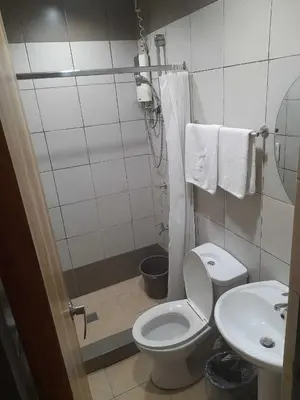 a bathroom with a toilet and a sink at OYO 1011 First Hotel in Manila