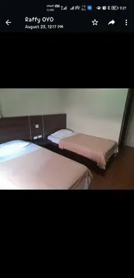 a picture of two beds in a room at OYO 1011 First Hotel in Manila