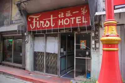 a hotel with a red and yellow pole in front of it at OYO 1011 First Hotel in Manila