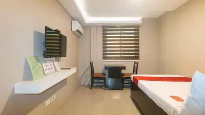 a hospital room with two beds and a desk at RedDoorz Plus at Seventy Five Inn Near Manila Airport in Manila