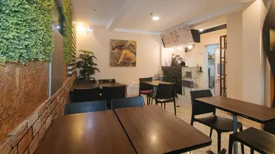 a dining room with wooden tables and chairs at RedDoorz Plus at Seventy Five Inn Near Manila Airport in Manila