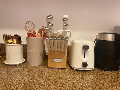 a counter with a bunch of knives and a toaster at Bohemian Inspired 2 Bedroom Inspired Condo with Fast WIFI Near BGC in Manila