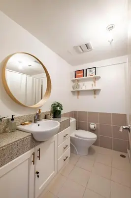a bathroom with a sink and a toilet and a mirror at Bohemian Inspired 2 Bedroom Inspired Condo with Fast WIFI Near BGC in Manila