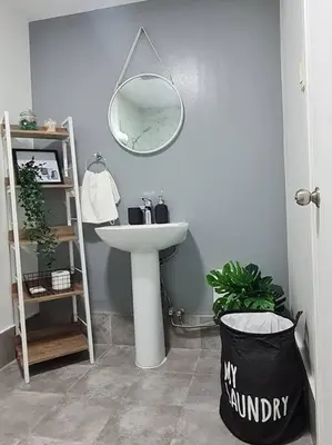 a bathroom with a sink and a mirror at Homey condo unit in BGC - B SOMA NT in Manila