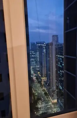 a view of a city from a window of a building at Homey condo unit in BGC - B SOMA NT in Manila