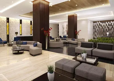 a lobby with couches and tables in a building at CozyCoastStay by APPLETRAVELBEYONDPH in Manila