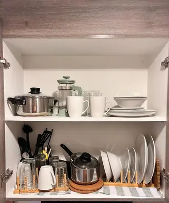 a shelf with dishes and utensils in a kitchen at CozyCoastStay by APPLETRAVELBEYONDPH in Manila