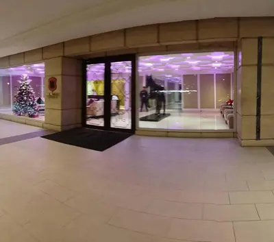 a lobby with a christmas tree in a building at Monarch Parksuites - Balmoral Place (near NAIA, MOA, MOA Arena, DFA) in Manila