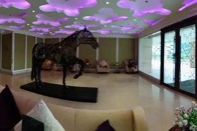 a statue of a horse in a room with purple lights at Monarch Parksuites - Balmoral Place (near NAIA, MOA, MOA Arena, DFA) in Manila