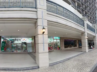 a building with a shopping mall with a store at Monarch Parksuites - Balmoral Place (near NAIA, MOA, MOA Arena, DFA) in Manila