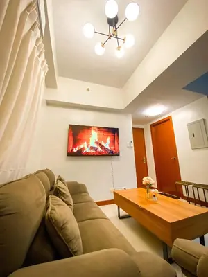 a living room with a couch and a table at Deluxe Room w/ Pool & Billiards in Manila
