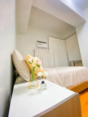 a room with a table with a vase of flowers on it at Deluxe Room w/ Pool & Billiards in Manila
