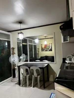 a kitchen with a table and chairs and a couch at V&J Transient Condotel in Manila