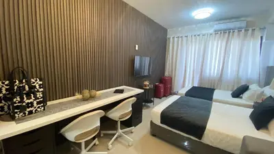a hotel room with a bed and a desk with chairs at Stay COZY and BOUJEE in Manila