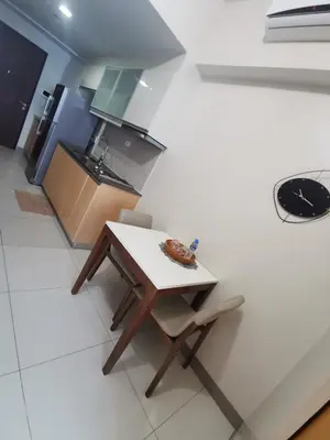 a small kitchen with a table and chairs in it at Caleze Properties Uptown Palazzo BGC One Bedroom in Manila