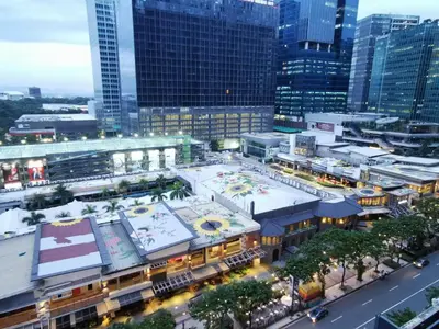 an aerial view of a city with a large building at Caleze Properties Uptown Palazzo BGC One Bedroom in Manila