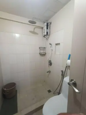 a bathroom with a shower and a toilet at Available Resort Type Condo Unit in Manila