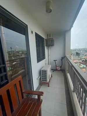 a balcony with a bench and a view of a city at Available Resort Type Condo Unit in Manila