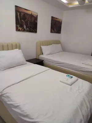 two beds in a hotel room with a scale between them at Need Place To Stay Booked Now Manila with Balcony Sea View, Promo Discount, Free Pool Plus Free Sauna Access Steps Away US Embassy, Updated 2026 Prices - Hurry Limited Time Only in Manila