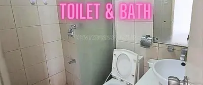 a bathroom with a toilet and a sink and a mirror at Need Place To Stay Booked Now Manila with Balcony Sea View, Promo Discount, Free Pool Plus Free Sauna Access Steps Away US Embassy, Updated 2026 Prices - Hurry Limited Time Only in Manila