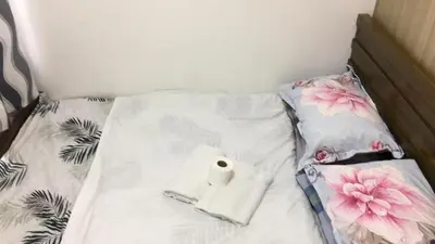 a bed with a roll of toilet paper on it at Shore residences Ph in Manila