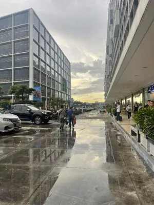 a group of people walking down a street in a city at Shore residences Ph in Manila
