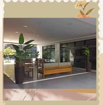 a building with a bench and a table and chairs at Avery's Place SMDC CHARM in Manila