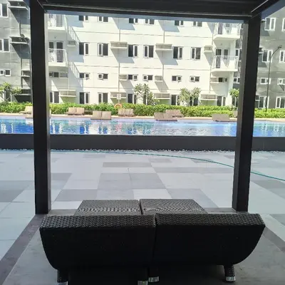 a couch in the middle of a swimming pool at Avery's Place SMDC CHARM in Manila