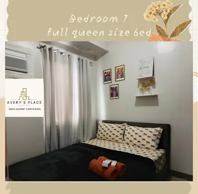 a bedroom with a bed with a black and white blanket at Avery's Place SMDC CHARM in Manila