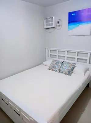 a white bed in a white room with at Sönmez Private Villa in Cavite