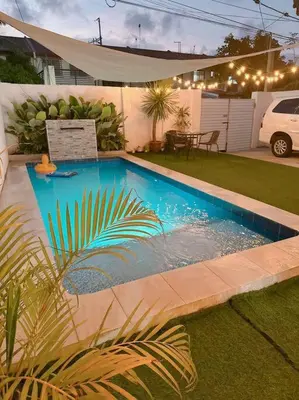 a swimming pool in a yard with a landscaping at Sönmez Private Villa in Cavite